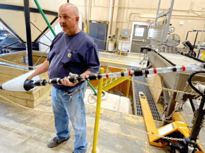 A civil engineering technician with the U.S. Army Engineer Research and Development Center shows the sand boil filter kit designed and developed at ERDC.