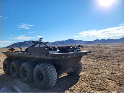A military vehicle sits in the desert.