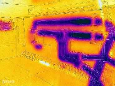 An infrared view of the interior of the enclosure shows purple tracings on a yellow background.