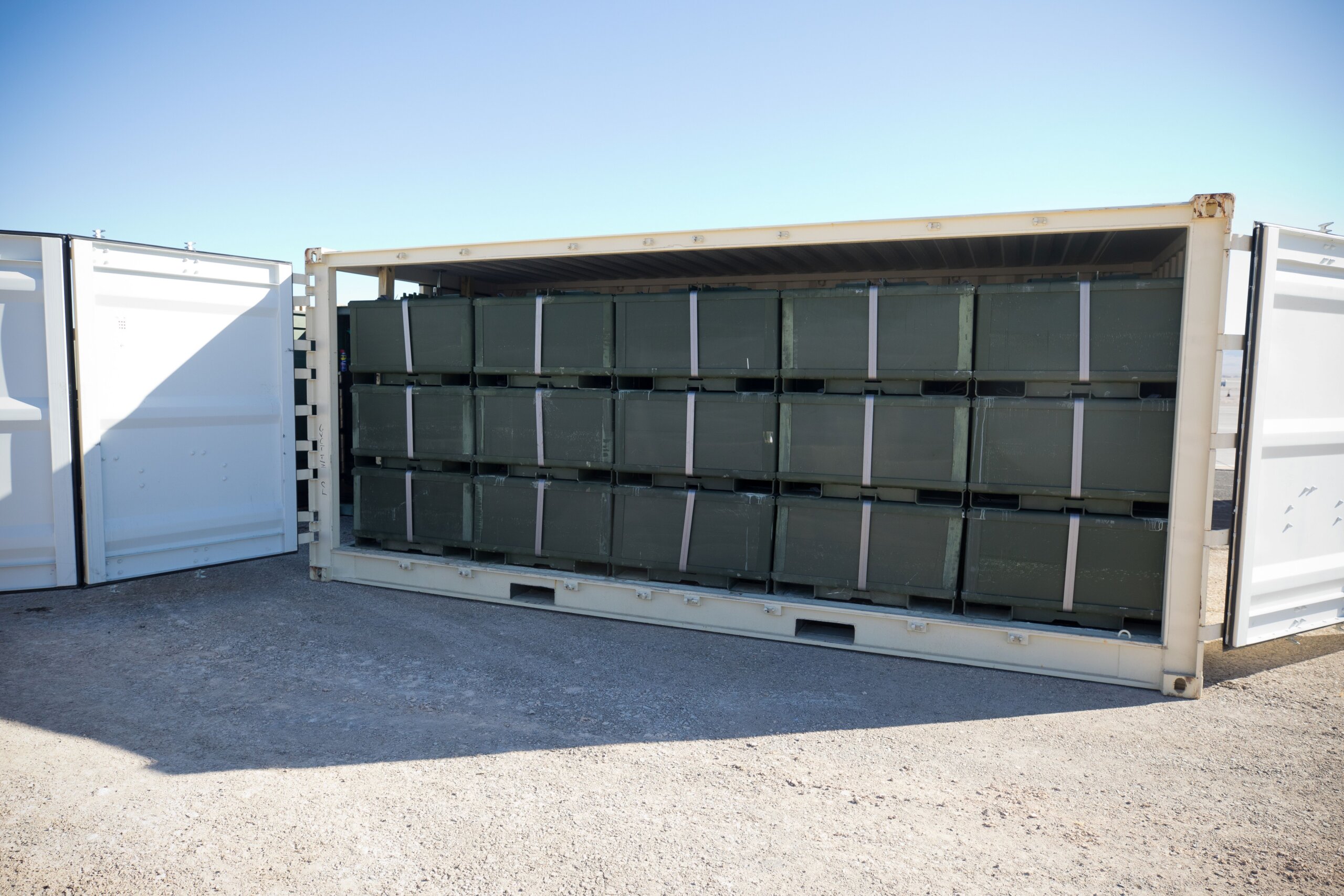 20 ft long shipping container with five stacks of AML bundles each three high
